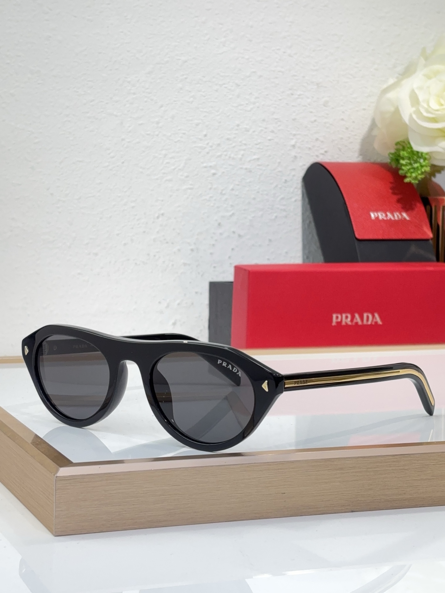 Prada Black Acetate Oval Sunglasses with Gold Accents (Model: PR04XS)