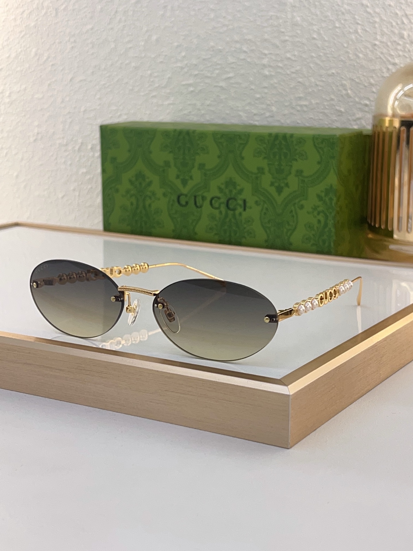 Gucci Gold - Tone Metal Oval Rimless Sunglasses with Pearl & Double G Accents (Model: GG1344S)